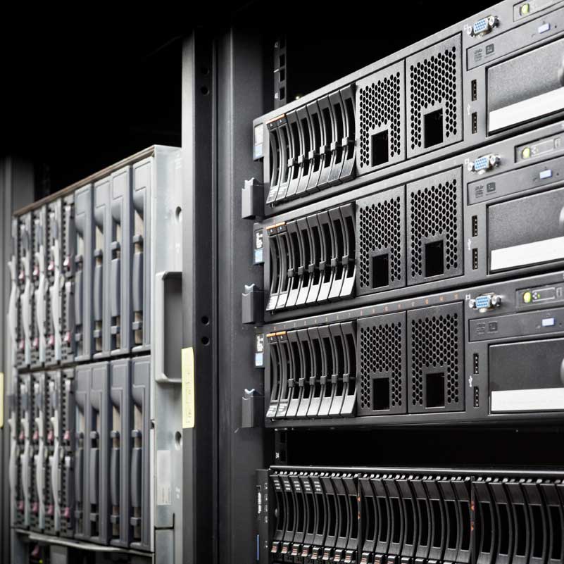 Rack-mounted servers in a data center, showing multiple hard drives and networking equipment.